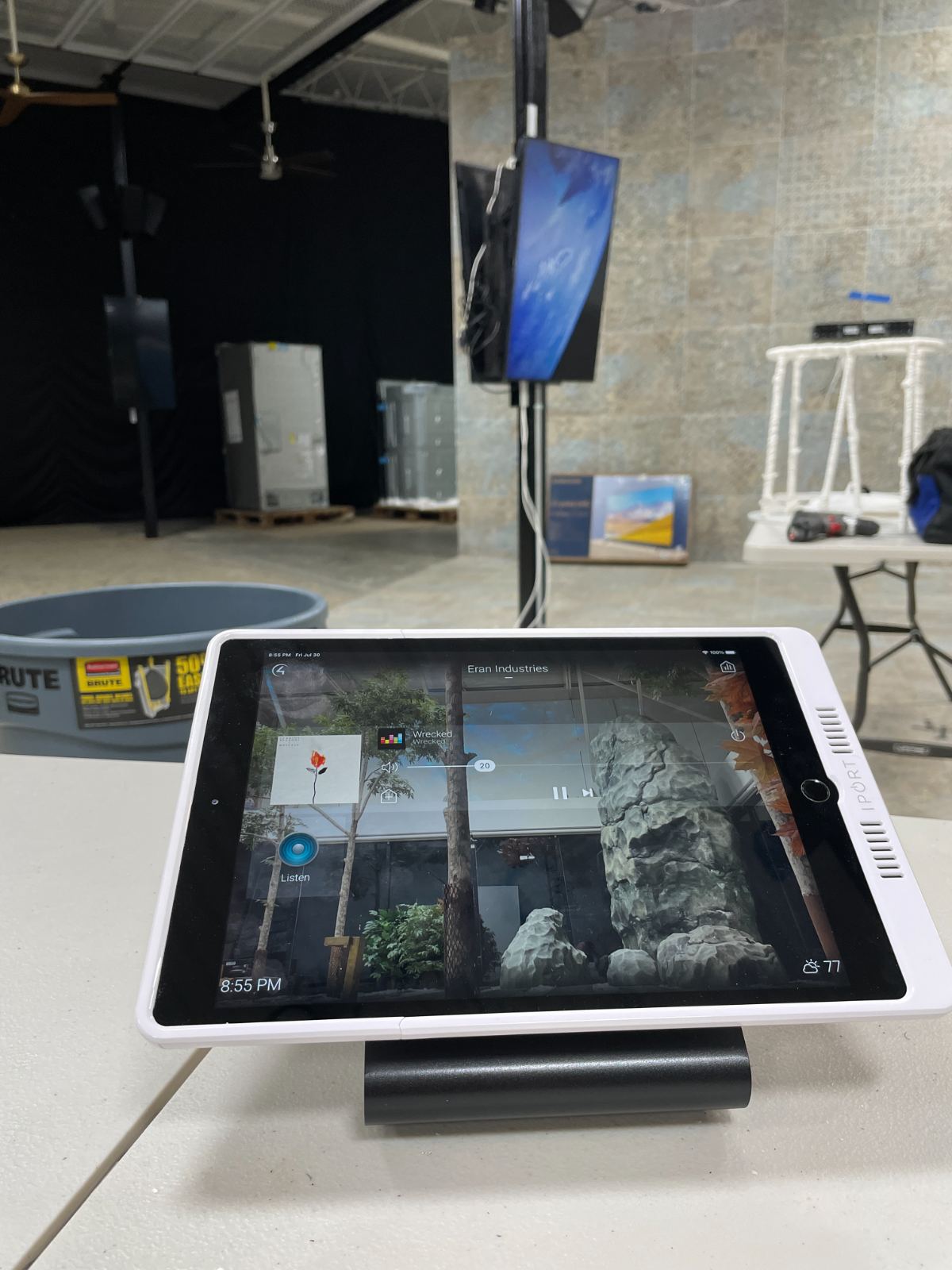 A studio floor with a camera and a control tablet on a stand
