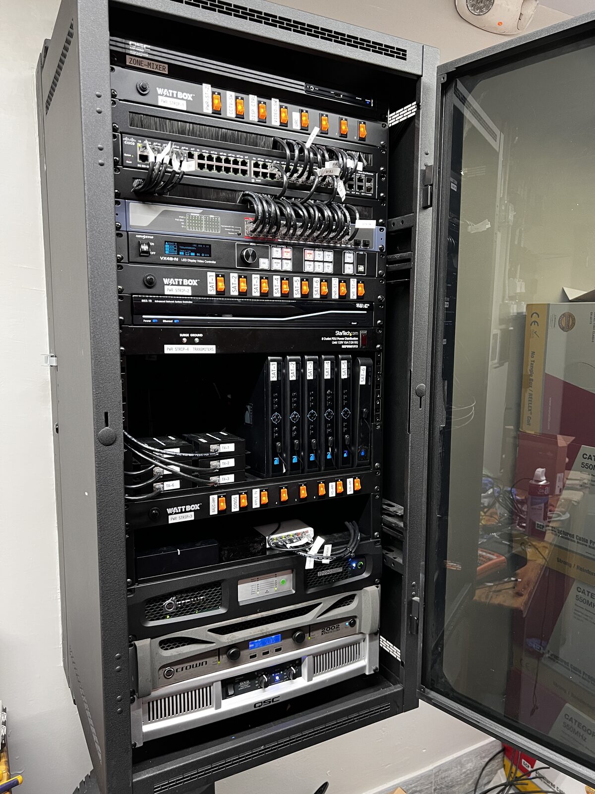 A venue equipment rack, open and fully dressed