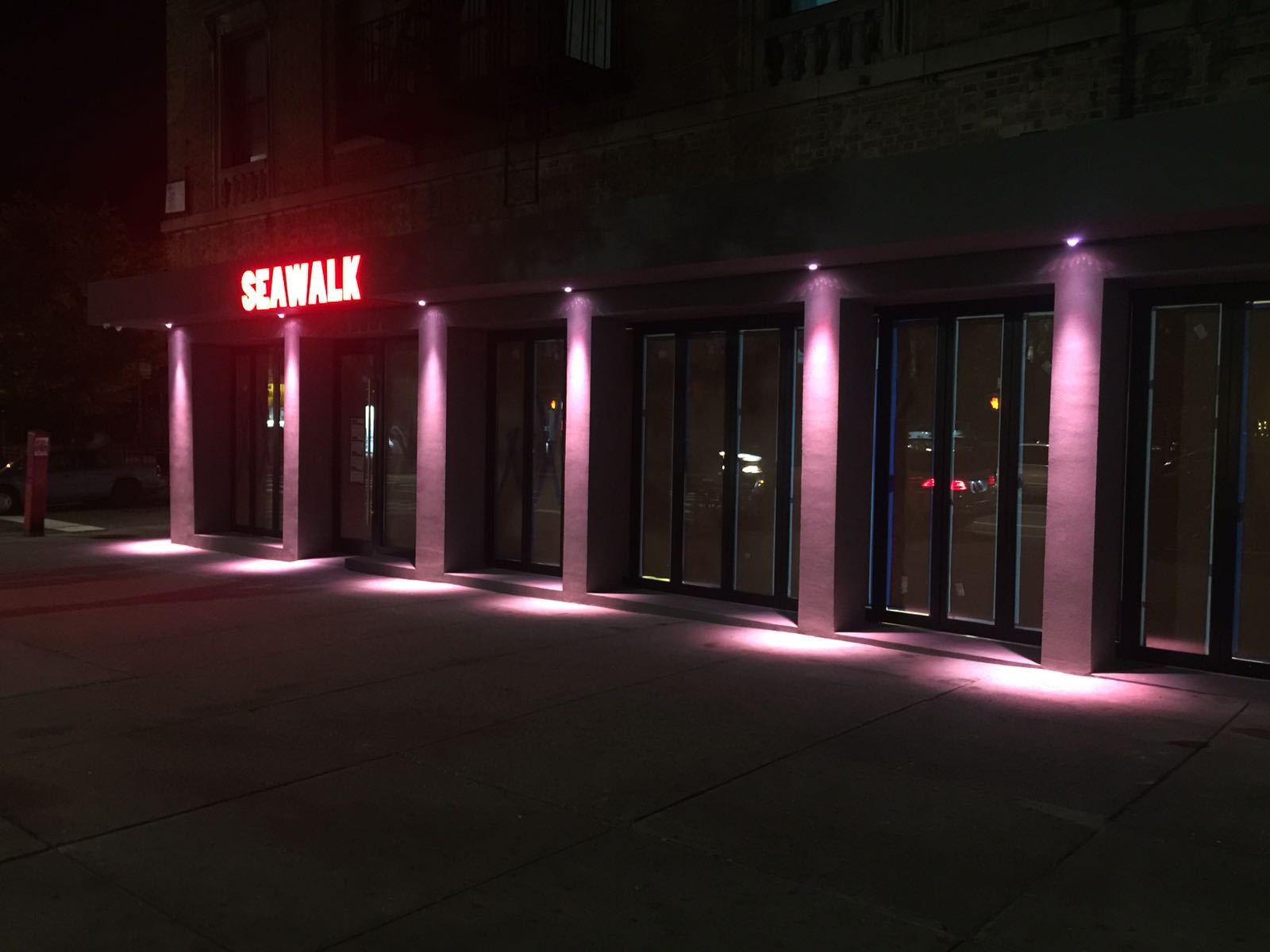 The restaurant's façade picked out in colour after dark