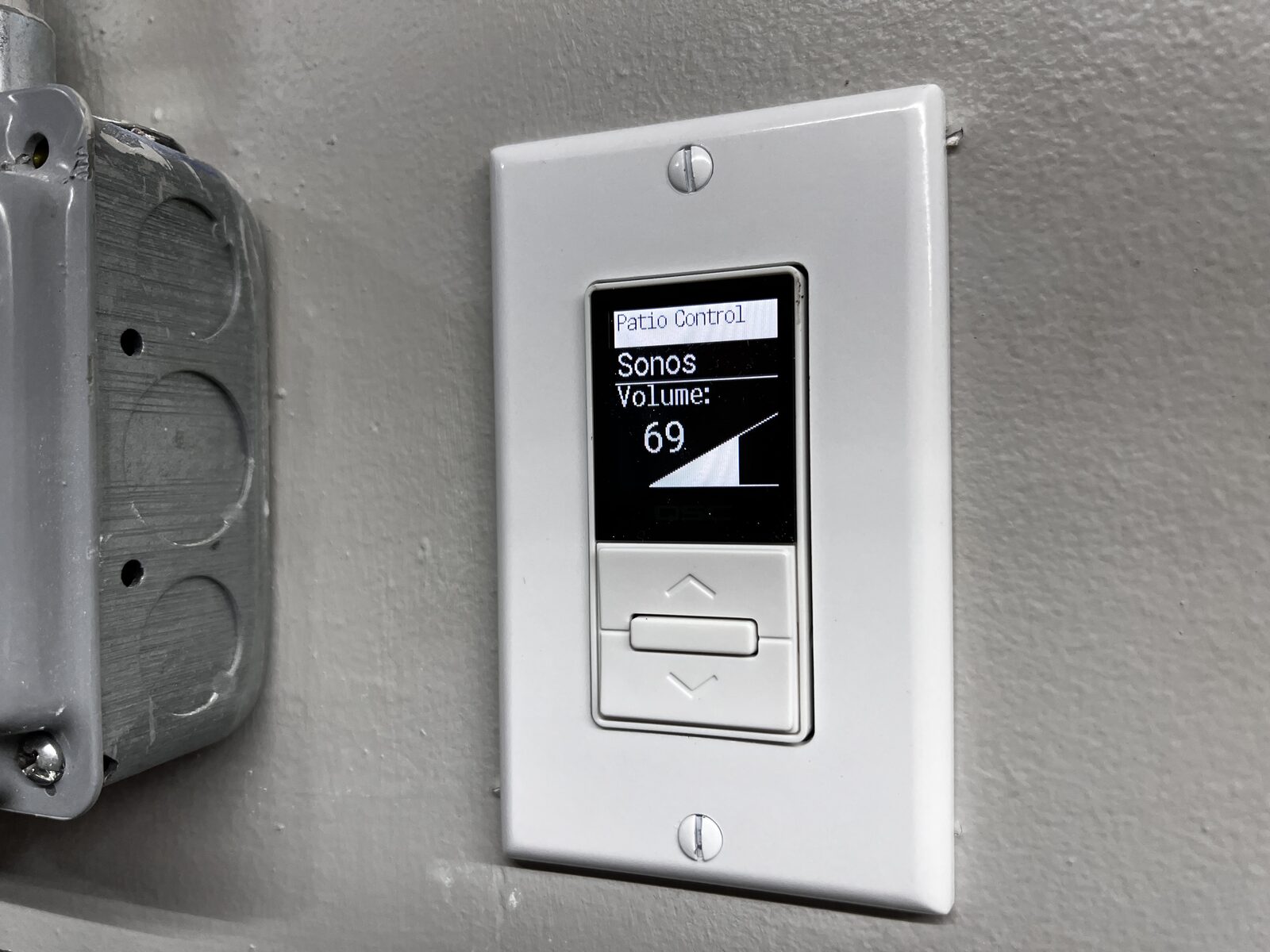 A wall keypad showing the patio zone's volume