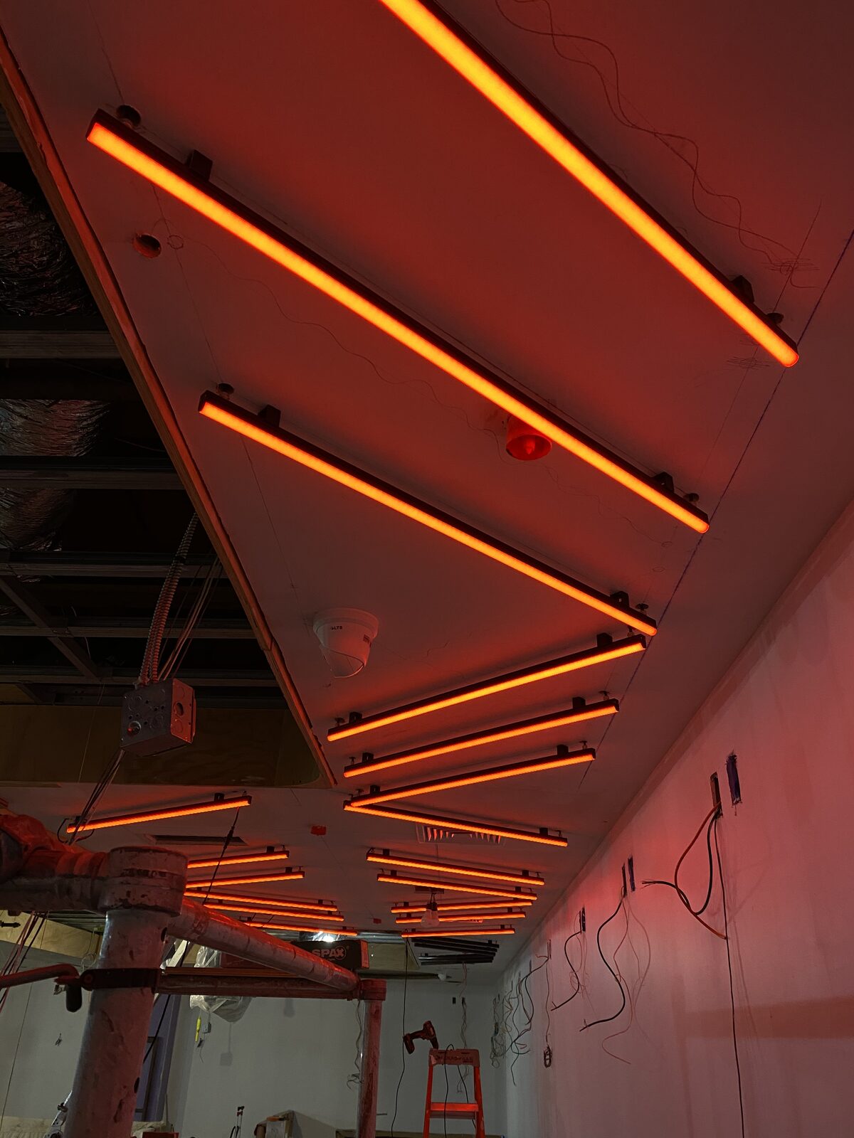 Linear LED fixtures set into the angled ceiling during install