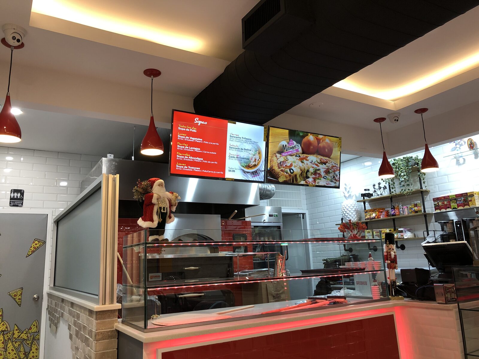 Digital menu boards mounted above a food counter