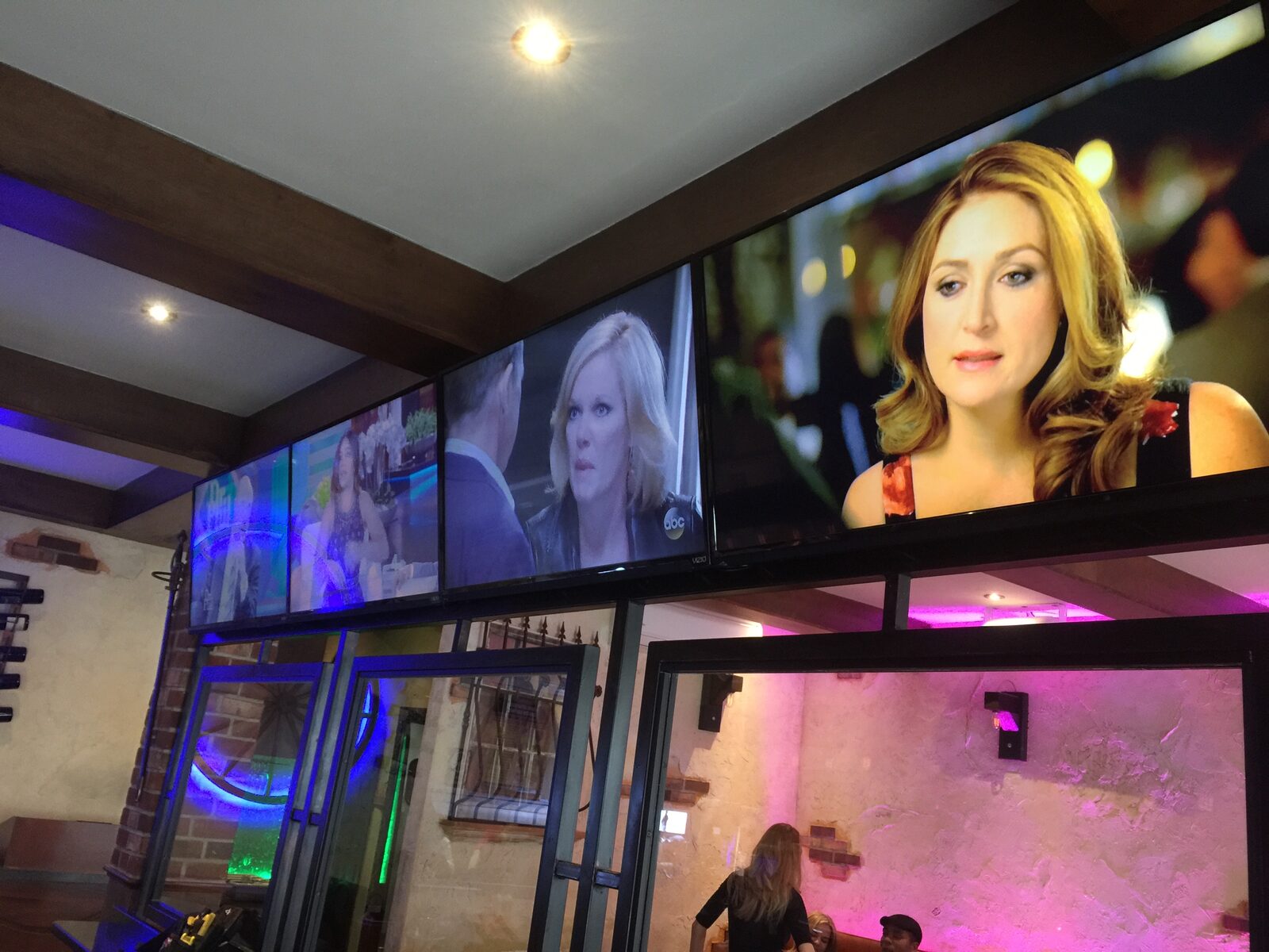 A row of displays set above a bar's street-facing glass