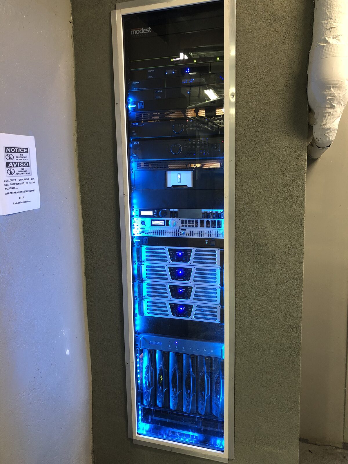 A slim equipment rack set into a wall niche