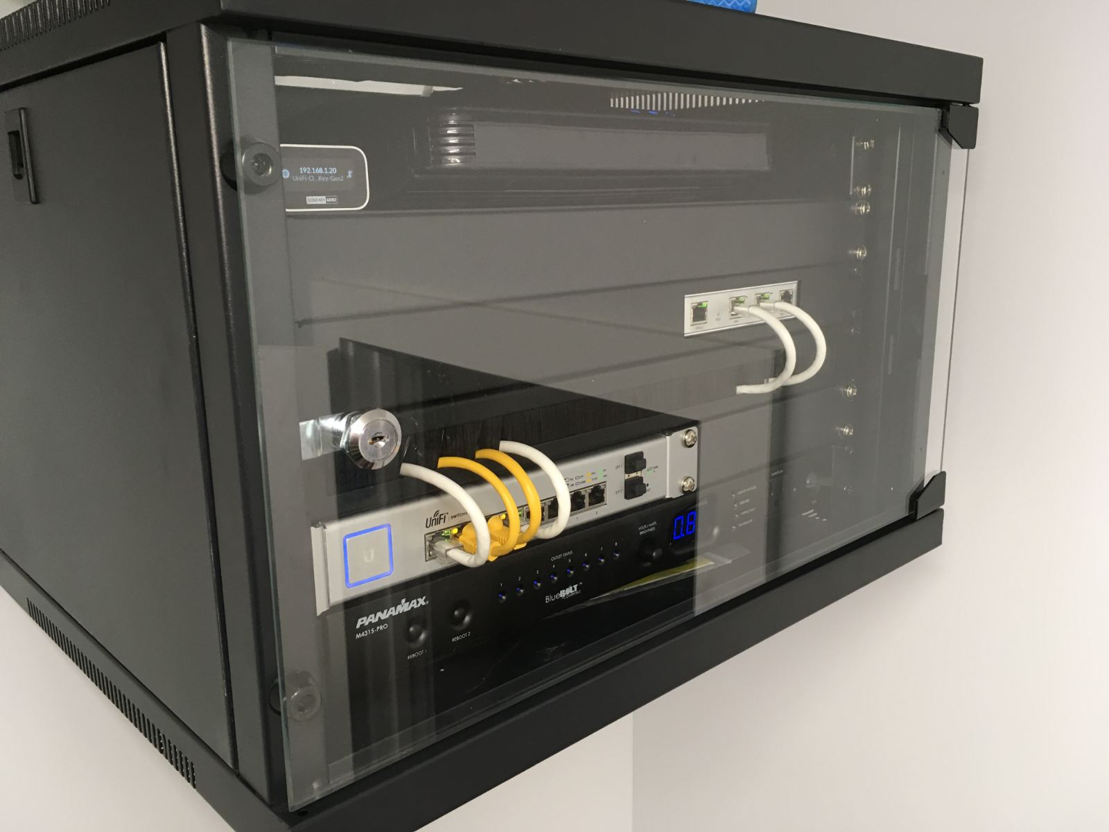 A wall-mounted rack enclosure serving an apartment