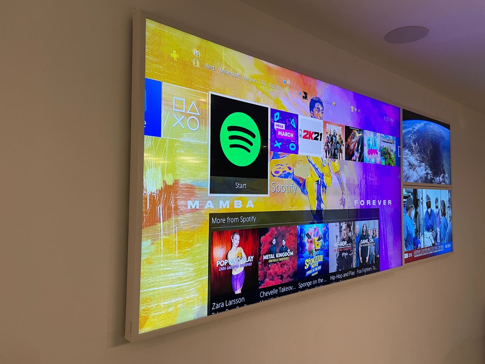 A wide media wall showing streaming and music services