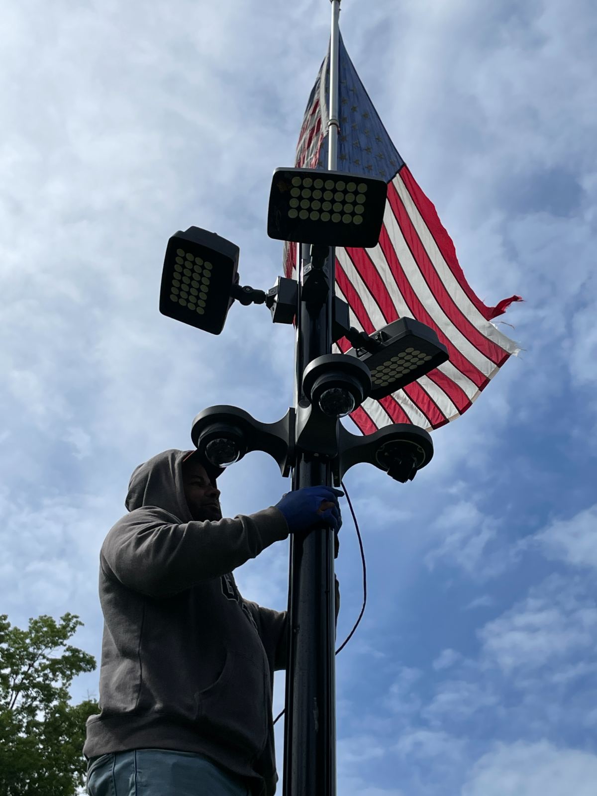 A floodlight and camera mounted high on a pole