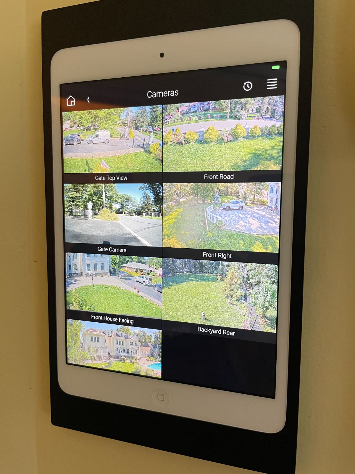 A wall-mounted tablet showing the property's camera views