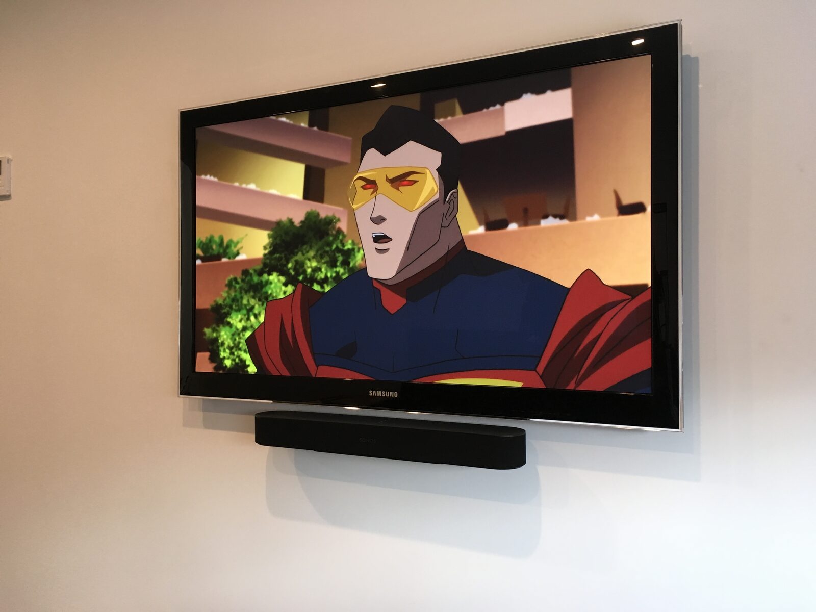 A wall display and soundbar mid-playback