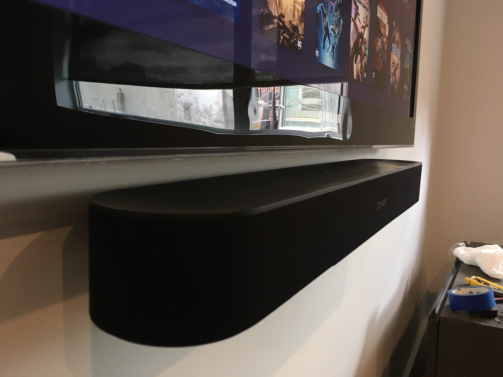 A soundbar mounted flush beneath the display