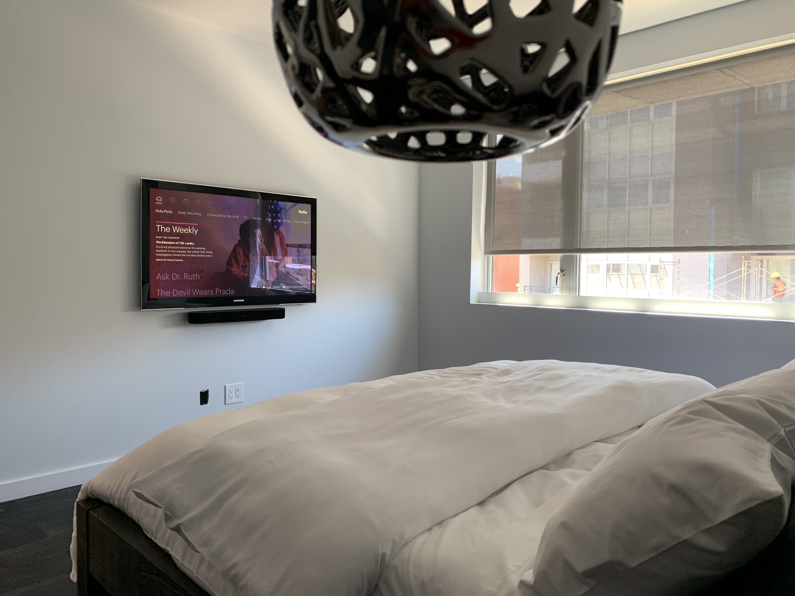 A bedroom display mounted opposite the bed