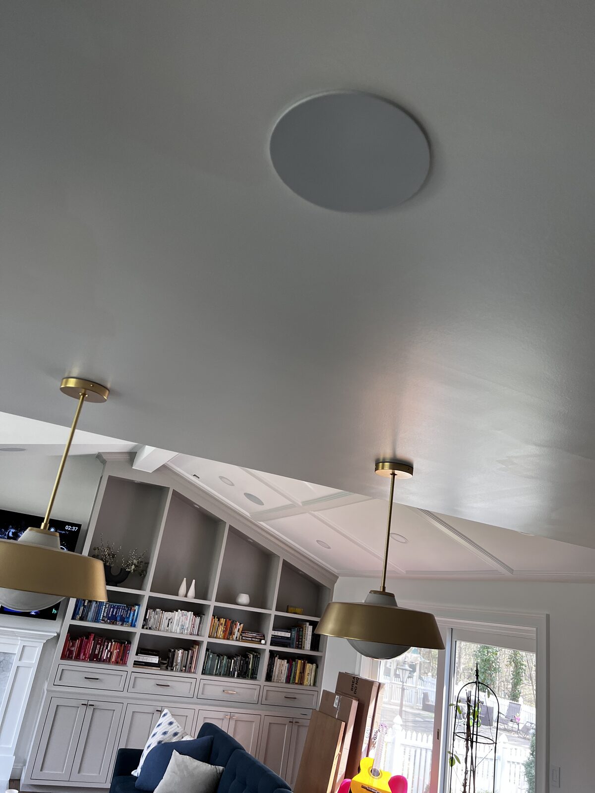 An in-ceiling speaker set flush into the plaster