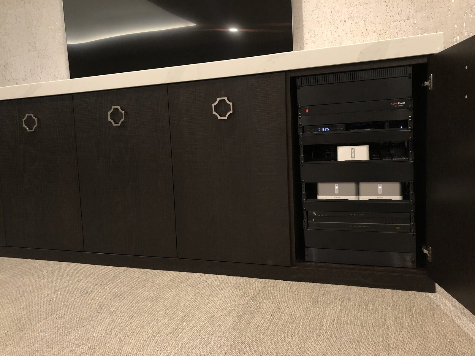 The equipment rack built into the room's millwork