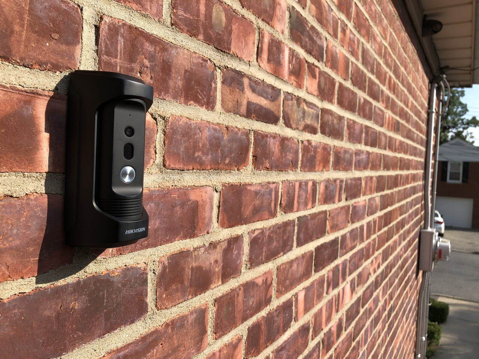 A doorbell camera set into the brick beside the entry